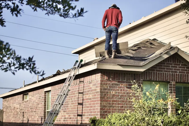 Professional roofer working on a residential roof in Virginia Key
